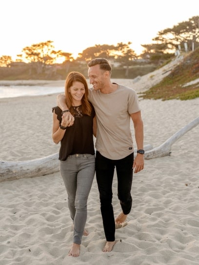 financially free couple walking on the beach